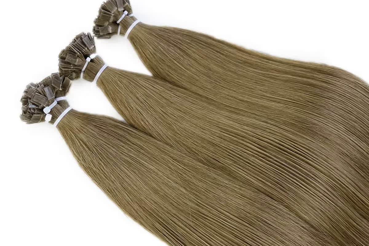 Three wholesale flat tip Remy human hair bundles compared for color match and stock consistency