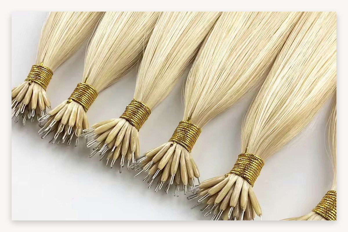 Close-up of tiny metal nano ring loops on wholesale Remy human hair extension strands for salon QC