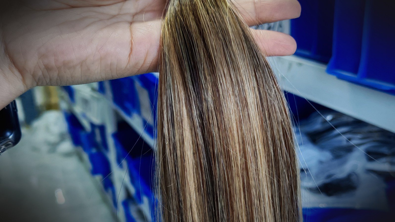 Salon buyer QC layout of wholesale hand tied weft hair extensions with thin single hand-sewn track on Virgin human hair bundles